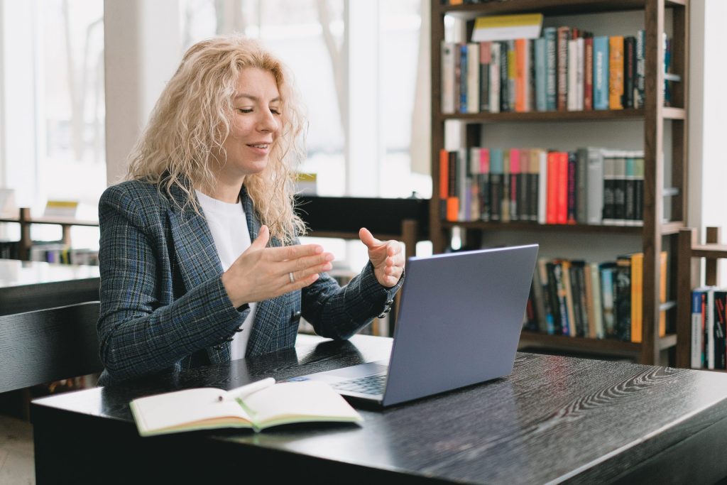 woman working remotely on laptop in an online meeting 